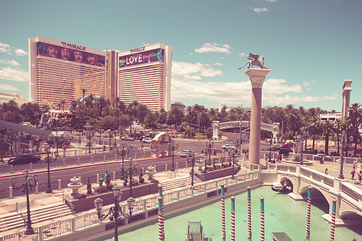 Las Vegas, Nevada, USA - May 18, 2017:  View of The Venetian and Mirage Hotel Resort and Casino along the Vegas Strip on a sunny day. This image has a vintage tone.