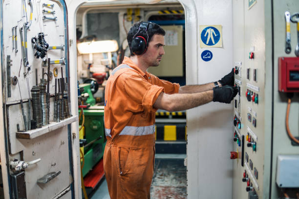 istock Marine engineer officer controlling vessel engines in engine control room ECR 958412096