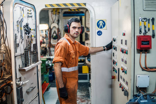 istock Marine engineer officer controlling vessel engines in engine control room ECR 958412118