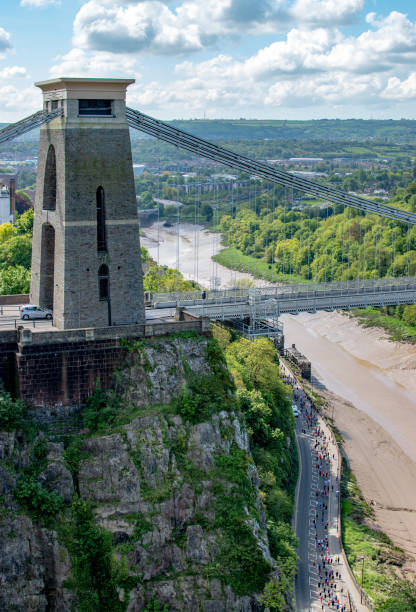 Runners at the Bristol 10k running under the Clifton suspension bridge along the Portway. stock photo