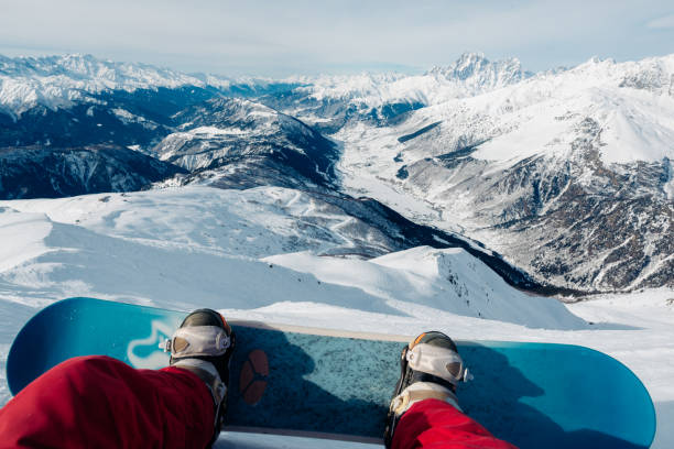 istock snowboarder with snowboard is sitting on the mountain 958427738
