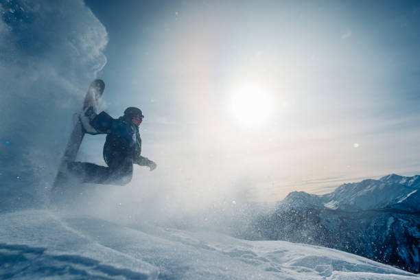 istock snowboarder is riding and jump from snow hill 958427936