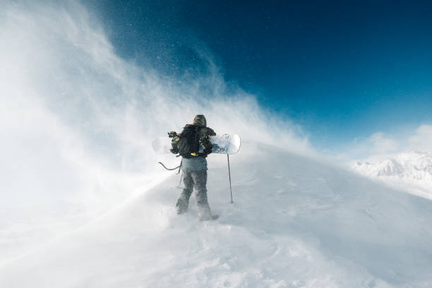 istock sportsman go with snowboard equipment 958428356