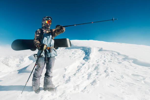 istock Snowboarder is standing with snowboard 958428422