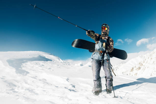 istock Snowboarder is standing with snowboard 958428666