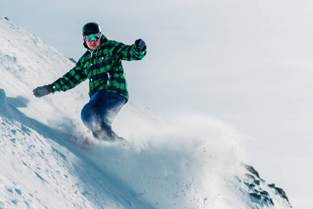 istock snowboarder is riding from snow hill 958428902