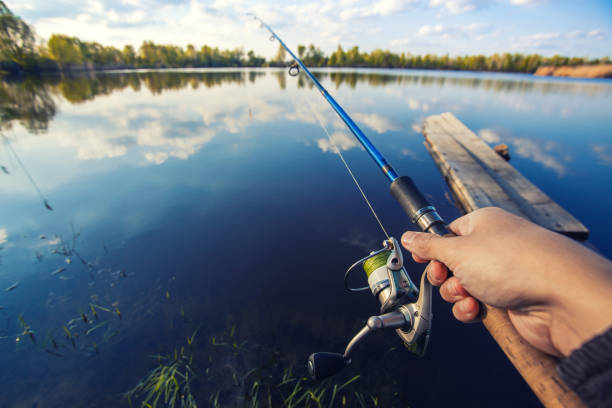 istock Fishing with rod on lake 958429630