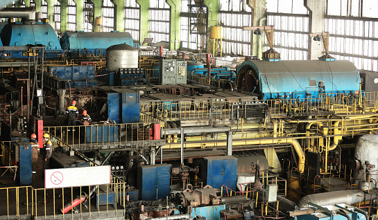 Power station. Machine room in thermal power plant with electric generators and turbines.