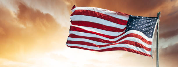 istock american flag against the sky at dusk 958433496