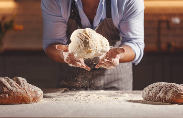hands of baker's male knead dough