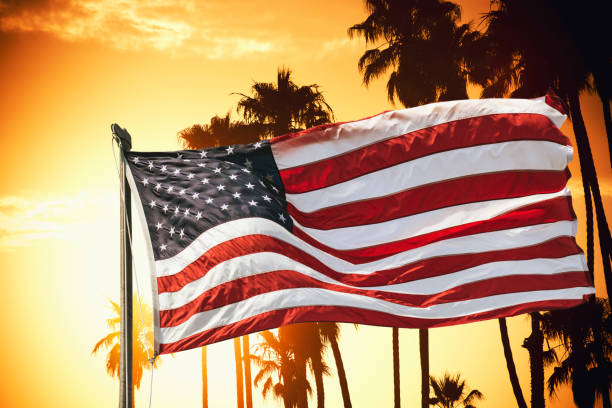 american flag against the sky at dusk