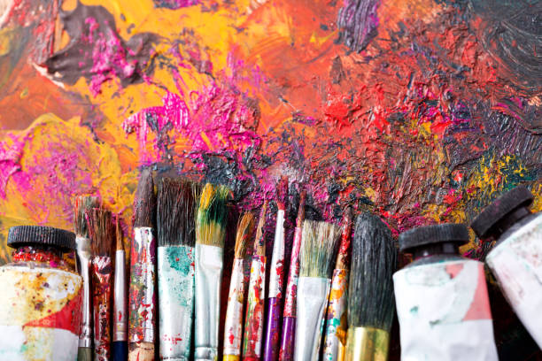 istock colorful paint brushes on a palette 958434604