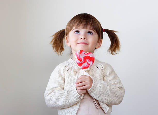 Girl and a lollipop stock photo