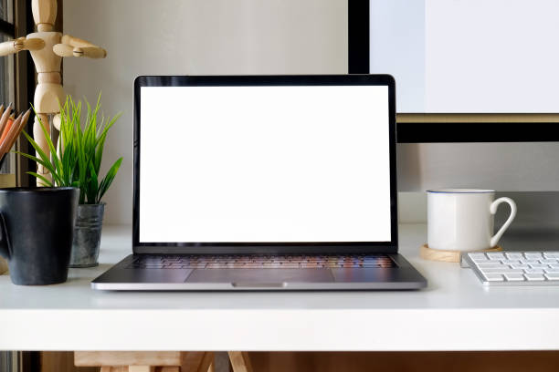 istock Office workspace with mockup laptop on white wood table. 958438516