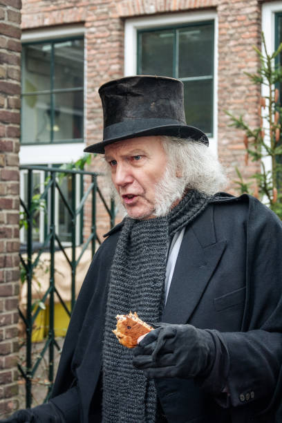 Scrooge acting during the Dickens Festival in Deventer Deventer, Netherlands – December 18, 2016: Scrooge one of the characters from the famous books of Dickens during the Dickens Festival in Deventer in The Netherlands deventer photos stock pictures, royalty-free photos & images