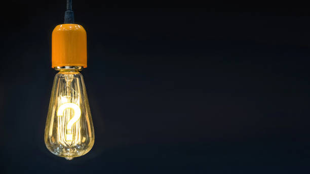 istock Question mark in the middle of retro lamps. 958443390