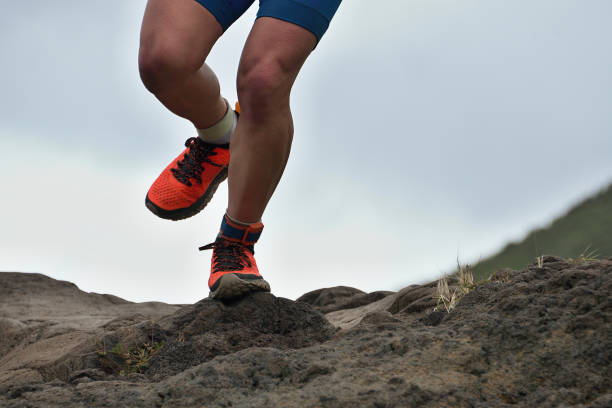 istock Athlete trail running in the mountains on rocky terrain 958446126