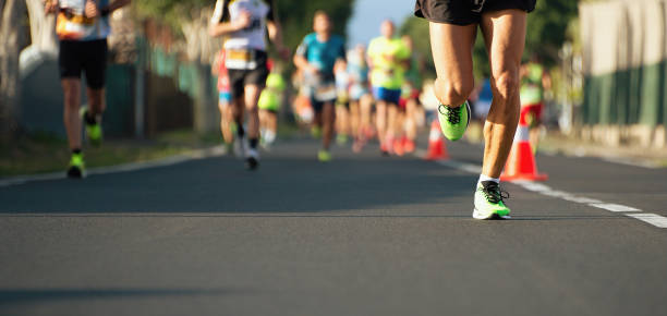 Marathon running race Marathon running race, people feet on city road running stock pictures, royalty-free photos & images