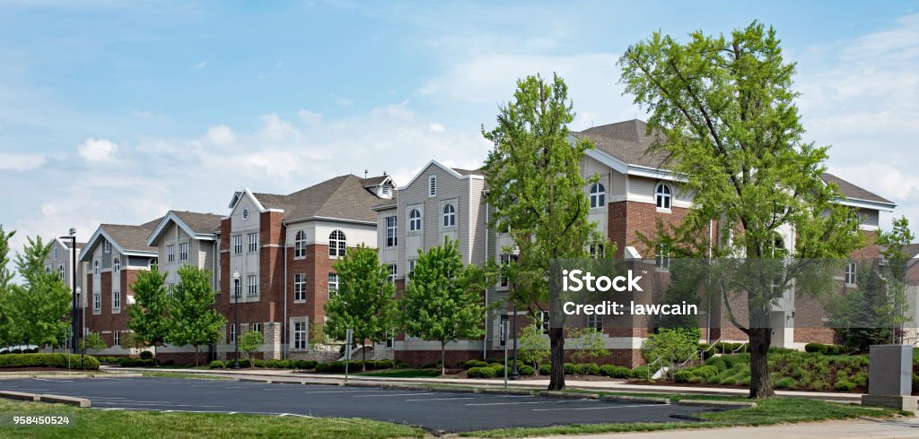 Upscale Red Brick & Tan Apartment Buildings Upscale red brick & tan apartment buildings for college student housing. Apartment Stock Photo