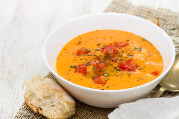 istock tomato soup in white bowl on wooden background 958451390