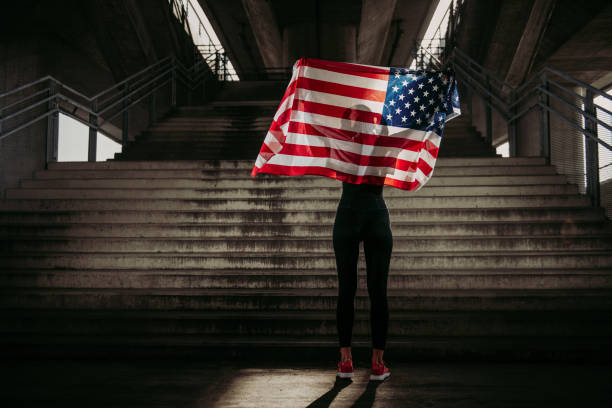 istock Young female athlete with American flag 958451526