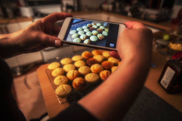 istock Taking a photo with a smart phone of cupcakes in a kitchen 958454486