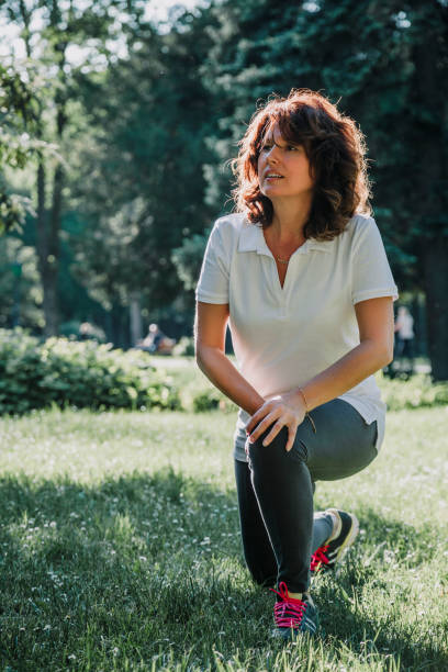 istock Mature fit woman practicing in public park 958457418