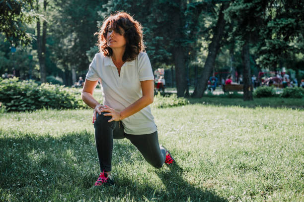 istock Mature fit woman practicing in public park 958457976