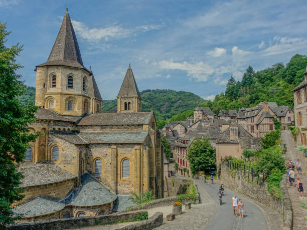 Conques, Midi Pyrenees, France - July 31, 2017: View of the medieval village of Conques and the Abbey Church of Saint Foy