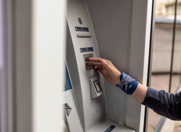 istock Man using his credit card in an atm for cash withdrawal 958461298