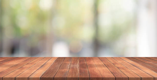 istock Empty wood table top on garden blurred background , space for montage show product 958466128