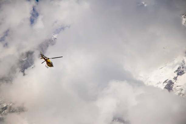 istock Image of a helicopter flying on a mountain area 958466368