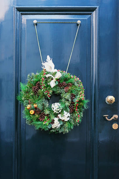 istock Christmas wreath attached to a blue door 958468982