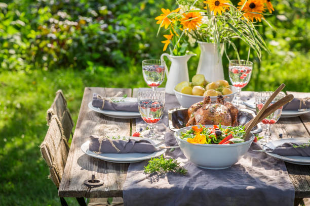 istock Dinner with salad and chicken served in summer garden 958469024