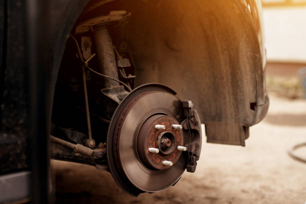 istock Old worn out rusty car wheel disk and breaks ready for repairs. 958469390
