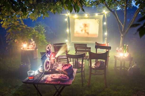 istock Small cinema with retro projector in summer garden 958471942