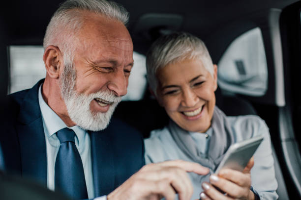 istock Senior couple looking and pointing towards mobile phone 958473206
