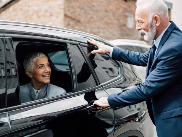 istock Gentleman opening car door for a lady 958473402