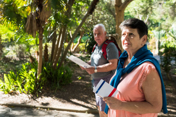 istock Senior couple with map walking in a city park 958473432