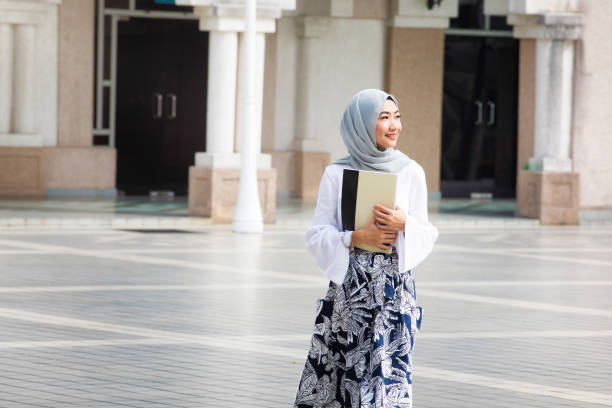 istock Female Muslim College student walking on campus 958479512