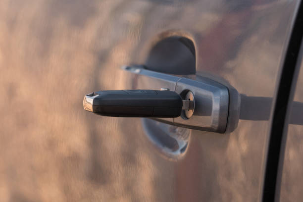 closeup on car key in a door lock