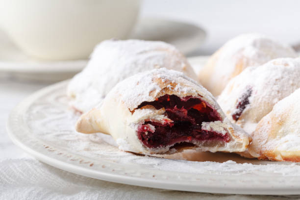 istock Delicious rustic pastries filled with berry on a ceramic plate on a wooden background. 958484172