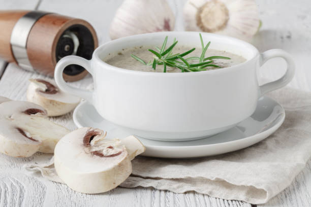 istock Fresh mashed mushroom soup with bread croutons and pepper on wooden background 958484296