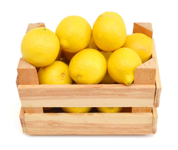 istock fresh lemons in a wooden box on a white background 958484336