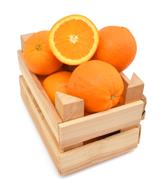 istock fresh oranges in a wooden box on a white background 958484394