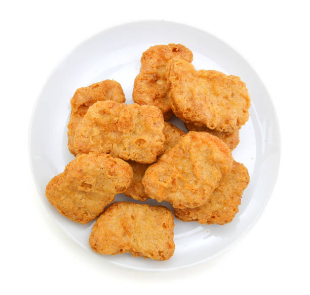 istock Fried chicken nuggets isolated in white plate on white 958487156