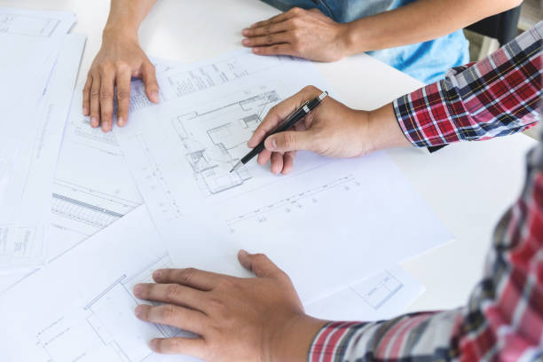 istock Architect working on blueprint, Engineer meeting working with partner colleagues and engineering tools for architectural project, Construction concept 958492272