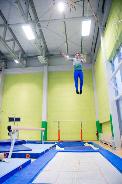 istock Young Adult Athlete Practicing on Trampoline 958492460