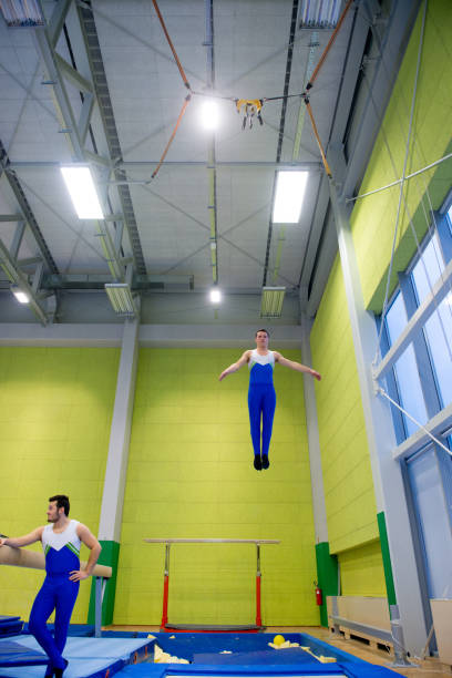 istock Young Adult Gymnastics Athletes Practicing on Trampoline 958492498