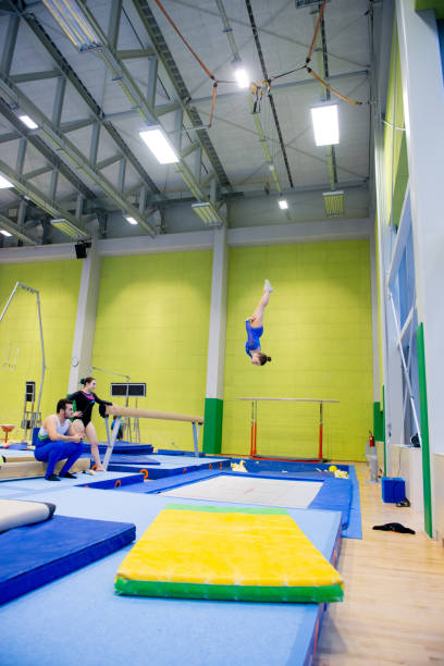 istock Young Adult Gymnastics Athletes Practicing on Trampoline 958492500